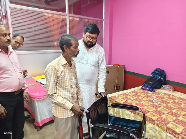হুইল চেয়ার তুলে দিচ্ছেন বিমান ঘোষ
